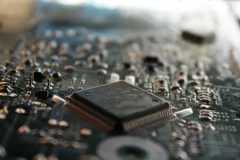 Artificial Intelligence in Daily Life: Practical Ways AI Is Changing How We Work Close-up of a microprocessor chip on a circuit board with shallow depth of field
