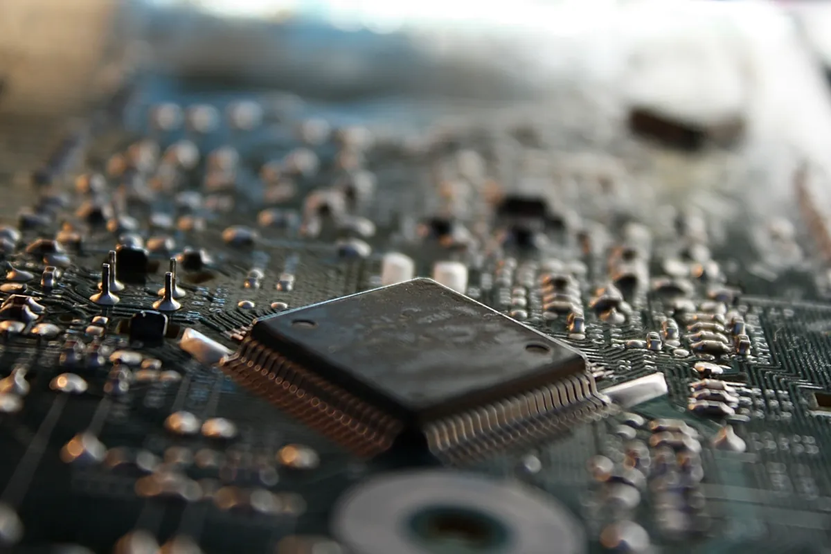 Close-up of a microprocessor chip on a circuit board with shallow depth of field