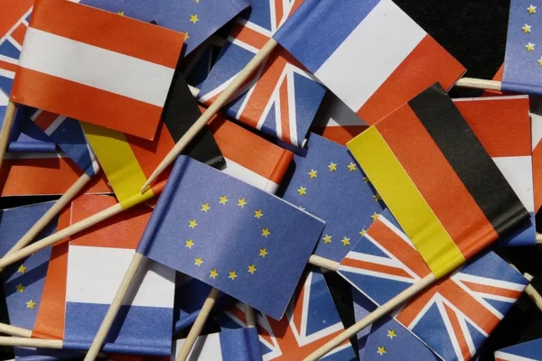 Understanding Global Diplomacy: How International Alliances Shape Everyday Life Colorful miniature national flags of European countries clustered together on small sticks